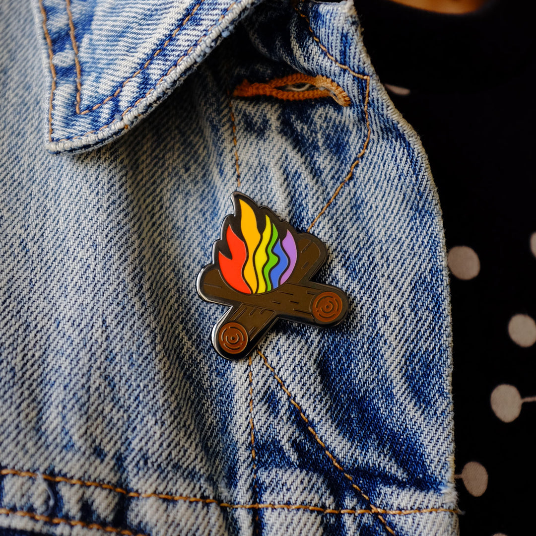 Flaming Rainbow Campfire Pride Pin, pinned to a jacket, by Bianca Designs