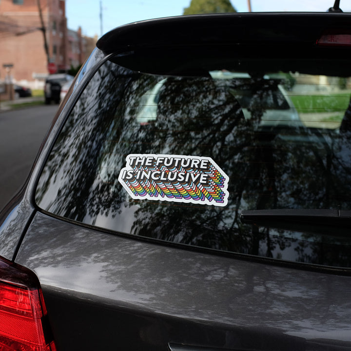 The Future Is Inclusive Bumper Rainbow Sticker by Bianca Designs on the rear window of a car.