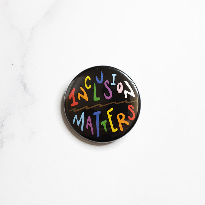 Inclusion Matters Rainbow Pinback Button by Bianca Designs.