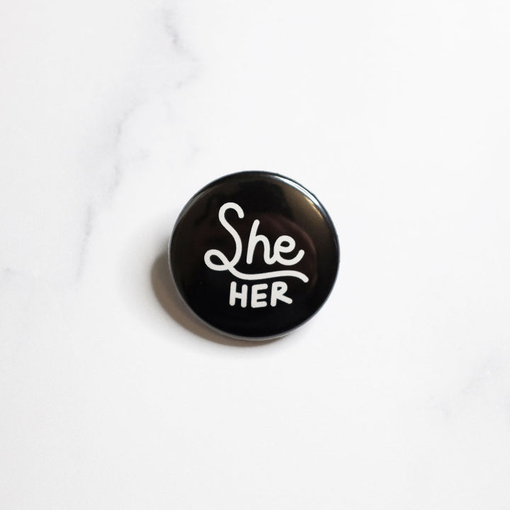 She/her Pronouns Button by Bianca Designs.