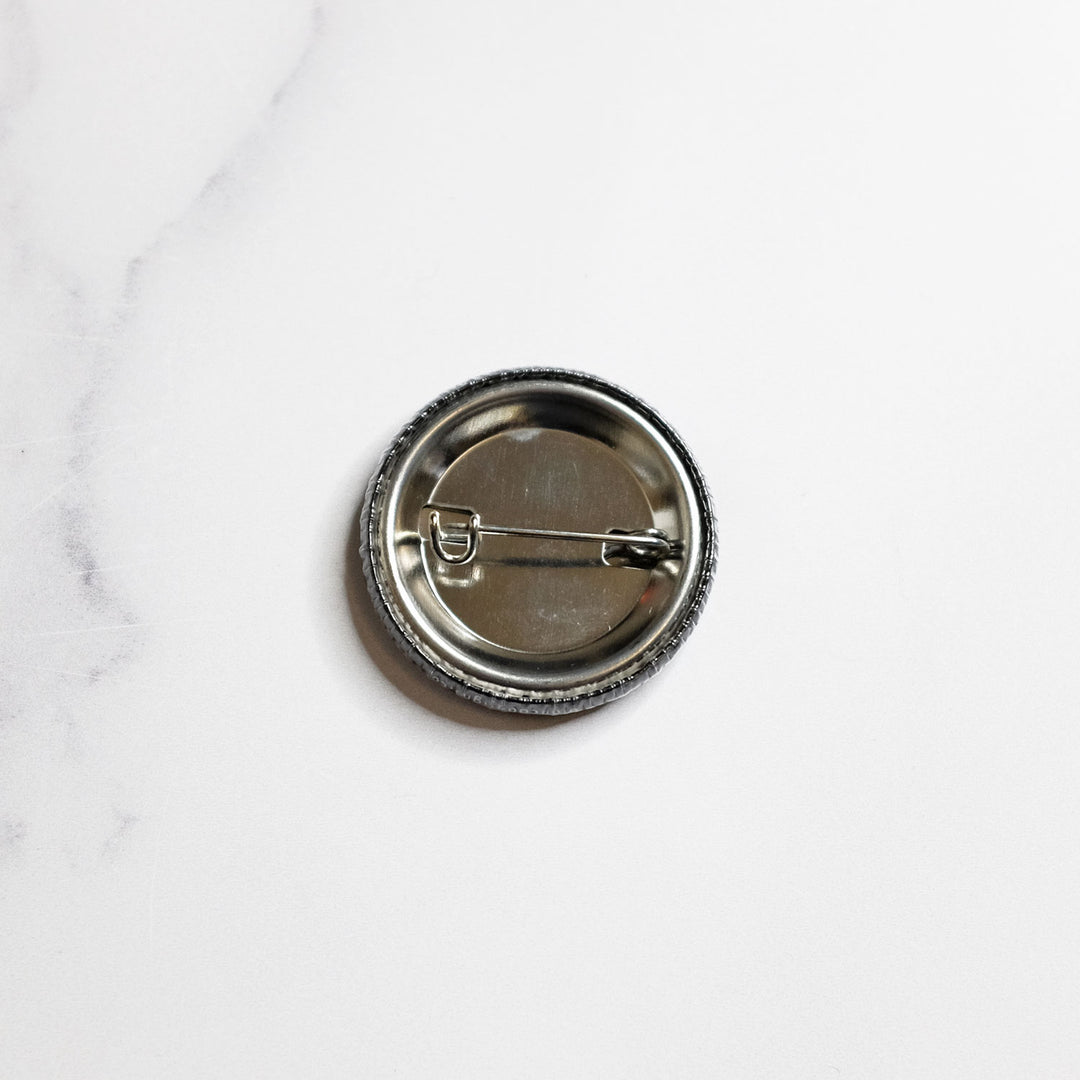 Back view of the She/they Pronouns Button by Bianca Designs.