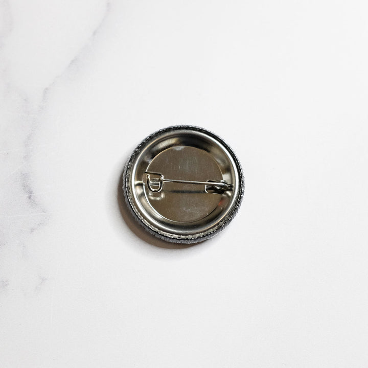 Back view of the She/they Pronouns Button by Bianca Designs.