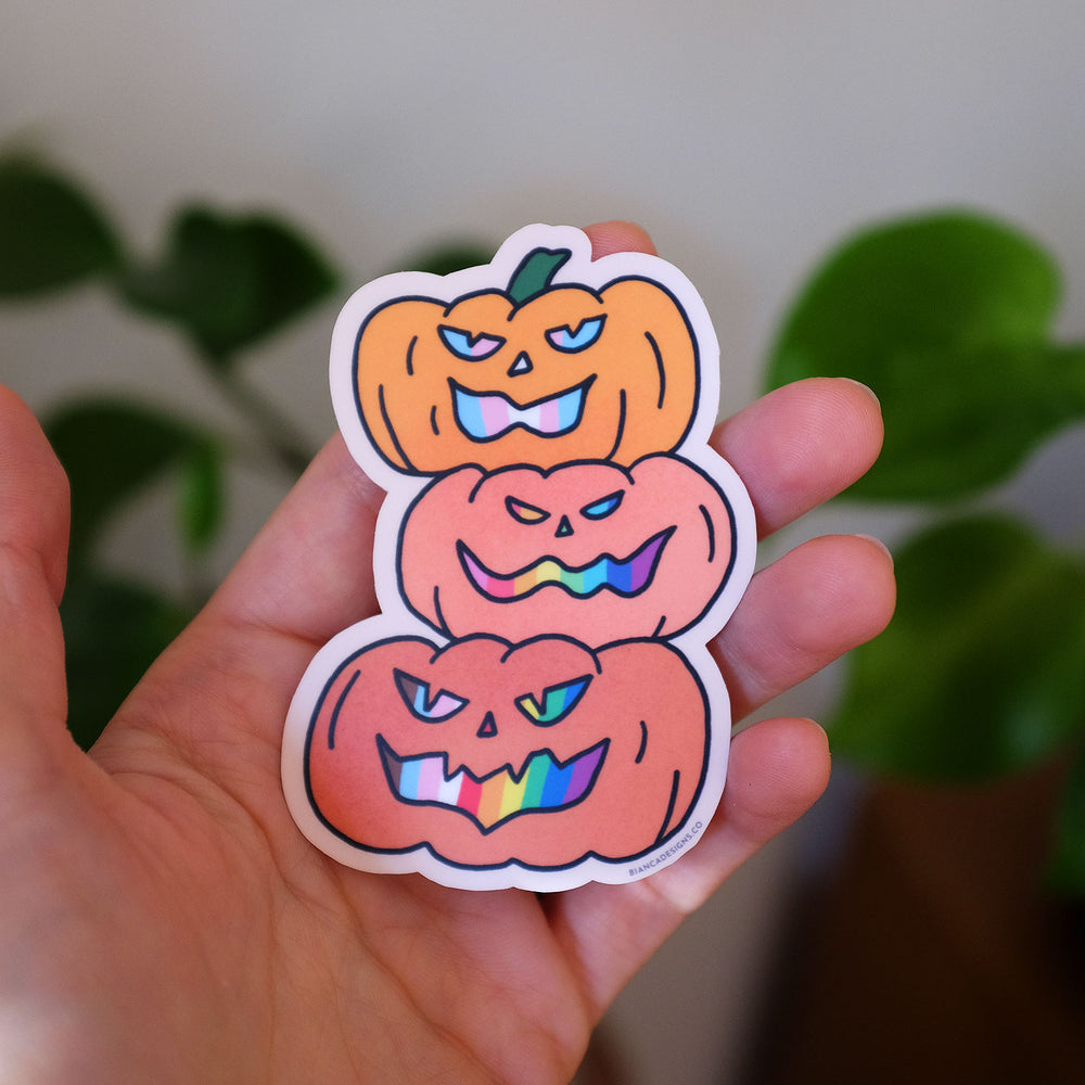 Hand holding the Stack of 3 Inclusive Pride Pumpkins Sticker by Bianca Designs